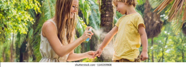 Mom And Son Use Mosquito Spray.Spraying Insect Repellent On Skin Outdoor BANNER, Long Format