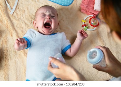 Mom Soothes Crying Baby With Water