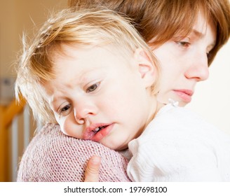 Mom Soothing Baby Daughter In Her Arms