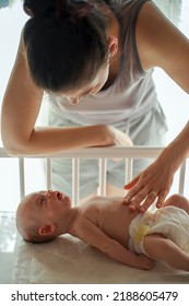 Mom Soothing Her Newborn Baby's Tummy Ache