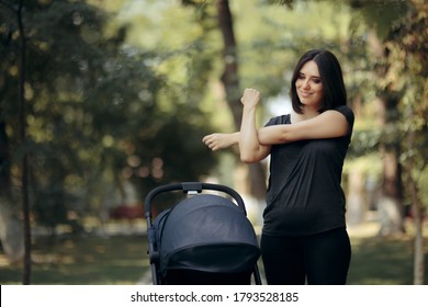 Mom Stretching Out After Workout Session In The Park. Sporty Mother Recovering After Birth Staying Active
