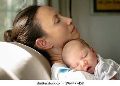 A Mom Taking A Nap With Her Baby At Home, Tired And Exhausted.