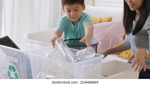 Mom teach Gen Z preteen boy kid dump paper glass can e-waste bag in reuse bin recycle bank help climate change social issue in asia people. Trash sorting clean eco green zero waste fun learn at home. - Powered by Shutterstock