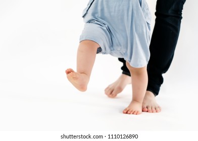 Mom is teaching baby to learn to walk