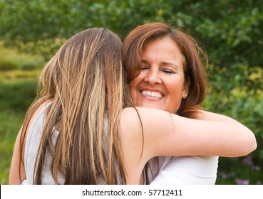 Mom With Teen Daughter Receiving A Hug