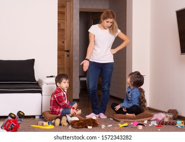 Mom Tired To Tidy Up The House. Child Scattered Toys. Mess In The House. Siblings