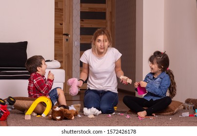 Mom Tired To Tidy Up The House. Child Scattered Toys. Mess In The Home.