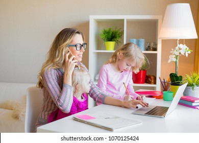 Mom With Two Daughters Working From Home