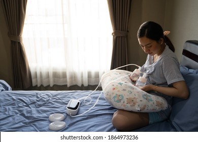 Mom use electric breast pump feeding for her baby.