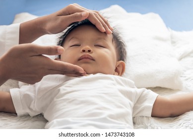 Mom Is Using Her Hands To Massage Under The Chin Of Child For To Open The Airway, Concept To Health Care For Child And Relax.