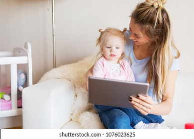 Mom using tablet together with her kid