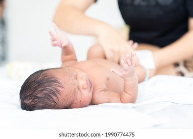 Mom Wiping Her Newborn Baby Skin, Face With Wet Wipes Carefully On Bed At Home. Family, Cleaning Wipe And Infant Concept