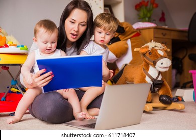 Mom works at a laptop with children