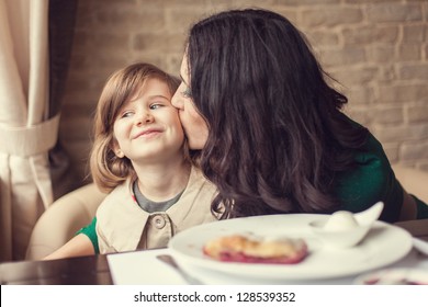 Mom And Young Daughter Eating Breakfast