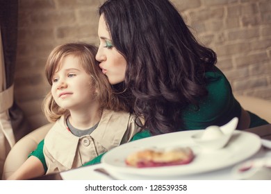 Mom And Young Daughter Eating Breakfast