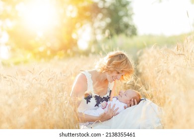 mom young girl breastfeeds a baby on a sunny day in nature. woman breastfeeding in nature. Mother's Day