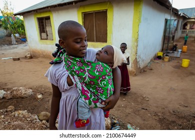 Mombasa. Kenya - 05.18.2021: Kenyan Girl With Baby. Mombasa. Kenya