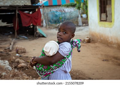 Mombasa. Kenya - 13.05.2021: Kenyan Girl With A Baby In Her Arms. Mombasa. Kenya