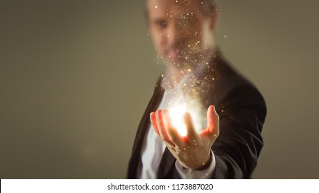 Moment Of Creation - Business Man Creating Energy Sparkles With His Hand