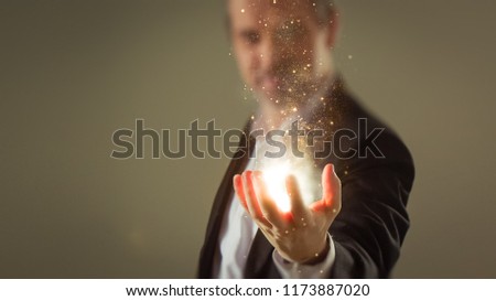 Moment of creation - Business man creating energy sparkles with his hand