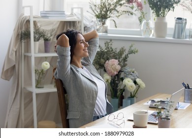 Moment of relax. Serene businesswoman florist owner of flower delivery service rest of computer work. Smiling calm lady floral decor specialist hold hands behind head enjoy quietness breath fresh air