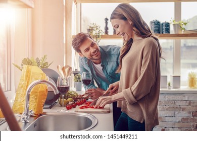 Moments Of Joy. Beautiful Young Couple Cooking Dinner While Standing In The Kitchen At Home