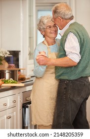 Moments Like These Are Beautiful. Shot Of A Senior Couple Enjoying A Playful Moment Together In The Kitchen.