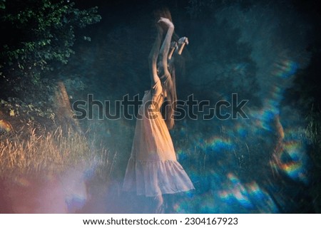 Moments of stillness. moments of self-care and self-soothing. Healing rituals and meditation. Dance Movement Therapy. Young woman dancing in nature background with reflection