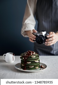 Mommy Blogger Photographs Green Homemade Pancakes With Spinach, Banana, Oats And Chocolate On Grey Background