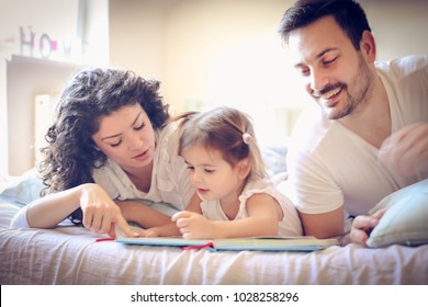 Mommy And Daddy Reading Me A Fairytale. 