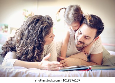 Mommy And Daddy Reading Me Stories Every Morning. Little Girl. 