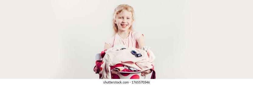 Mommy Little Helper. Smiling Caucasian Girl Child Holding Wash-basin With Clothes And Laundry Detergent Pods. Home Chores Housework For Children. Web Banner Header For Website.