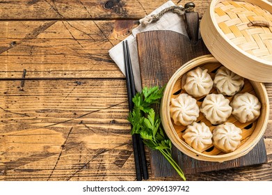 Momo Dumplings In A Bamboo Steamer. Wooden Background. Top View. Copy Space