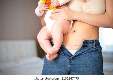 Mom's abdomen after cesarean section. Scar seam. A young mother holds the baby in her arms. Real motherhood. Lifestyle