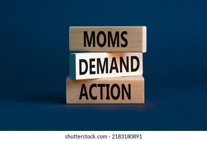 Moms demand action symbol. Concept words Moms demand action on wooden blocks on a beautiful grey table grey background. Business, finacial and Moms demand action concept. Copy space.