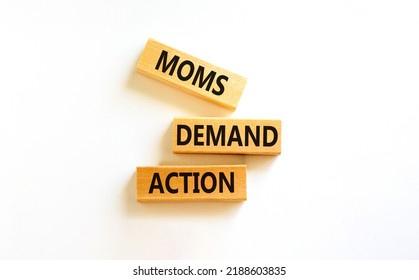 Moms demand action symbol. Concept words Moms demand action on wooden blocks on a beautiful white table white background. Business, finacial and Moms demand action concept.