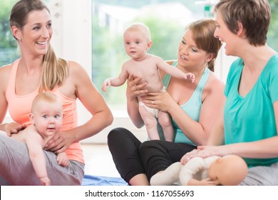 Moms And Their Babies Practicing Diaper Change In Mother And Child Class