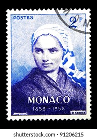 MONACO - CIRCA 1958: A stamp printed in Monaco shows a Bernadette Soubirous (1844-1879) with the inscription "1858-1958" from series "Centenary of Apparition of Virgin Mary at Lourdes", circa 1958