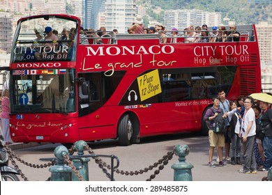 MONACO, MONACO - JUNE 17, 2015: Unidentified people enjoy sightseeing tour on the red Monaco city tour bus in Monaco.