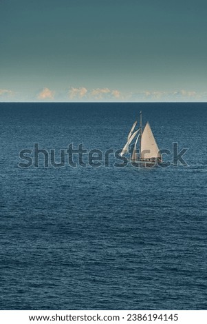 Monaco, lonely vintage sail yacht in sea at sunset, huge sail boat, wealth life of billionaires 