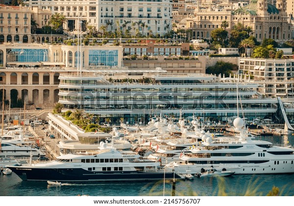 Monaco, Monte Carlo, 21 August 2017: Aerial view of
port Hercules at sunset, mega yachts are moored in marina near
yacht club of Monaco, view of city life from old town, a lot of
mega yachts and boats