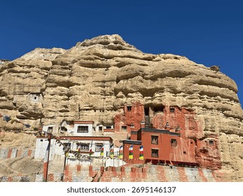 Monastery built into a cliffside in Upper Mustang, a remote region of Nepal. This area, often referred to as the 