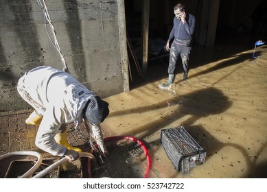 Moncalieri, Italy-November 27, 2016: Flood Victims Clean The Finished Houses Under Water After The Flood Of November 25 In The Town Of Moncalieri Near Turin, Italy