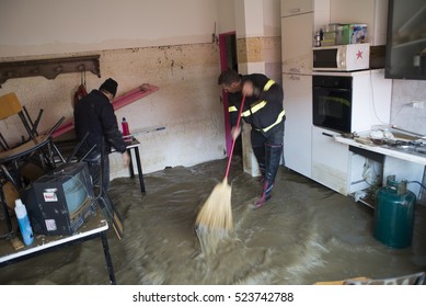 Moncalieri, Italy-November 27, 2016: Flood Victims Clean The Finished Houses Under Water After The Flood Of November 25 In The Town Of Moncalieri Near Turin, Italy