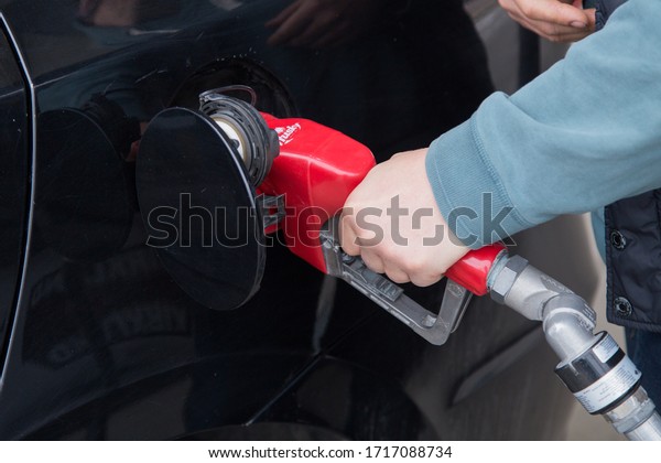 Moncton, New Brunswick, Canada -\
27 April 2020 A man buying cheap fuel at the Costco gas\
station.