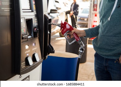 Moncton, New Brunswick, Canada - 28 March 2020 A Man Buying Cheap Fuel At The Costco Gas Station.