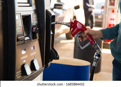 Moncton, New Brunswick, Canada - 28 March 2020 A Man Buying Cheap Fuel At The Costco Gas Station.