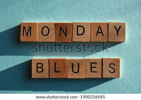 Monday Blues, words in wooden alphabet letters isolated on pale blue background