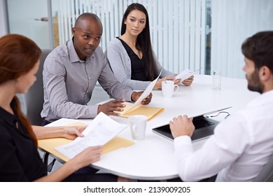 Monday Meetings Are Always Serious. Shot Of Colleagues Sitting In A Meeting.