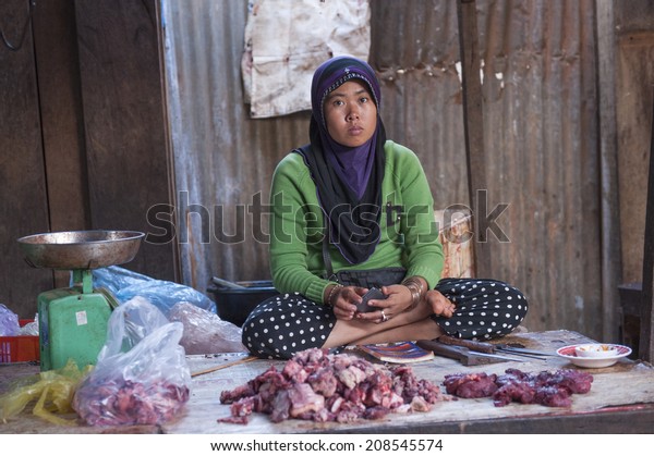 MONDULKIRI, CAMBODIA - JANUARY 4, 2013:\
Unidentified muslim cham woman at the market in Mondulkiri,\
Cambodia on January 4, 2013 in Siem Reap, Cambodia.\
